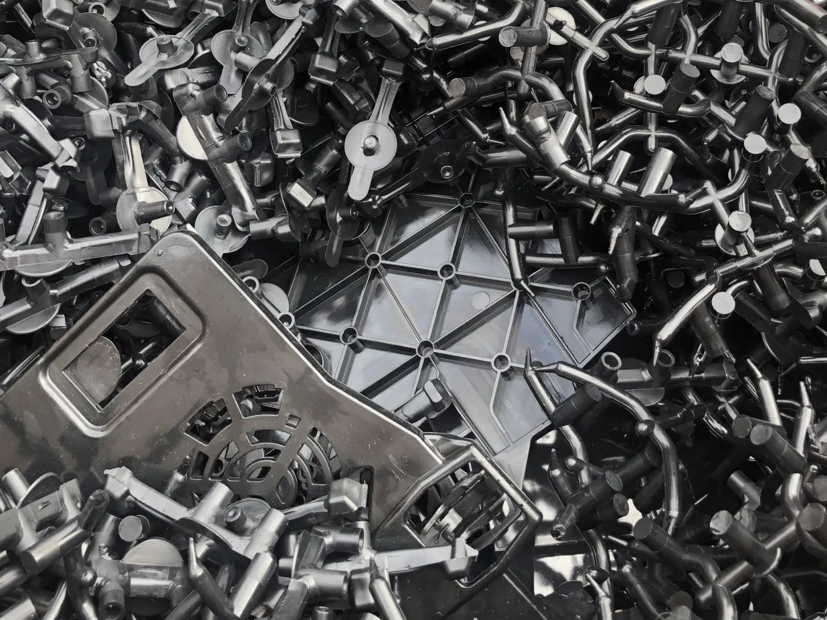 Black injection-moulded plastic components and production offcuts collected for recycling