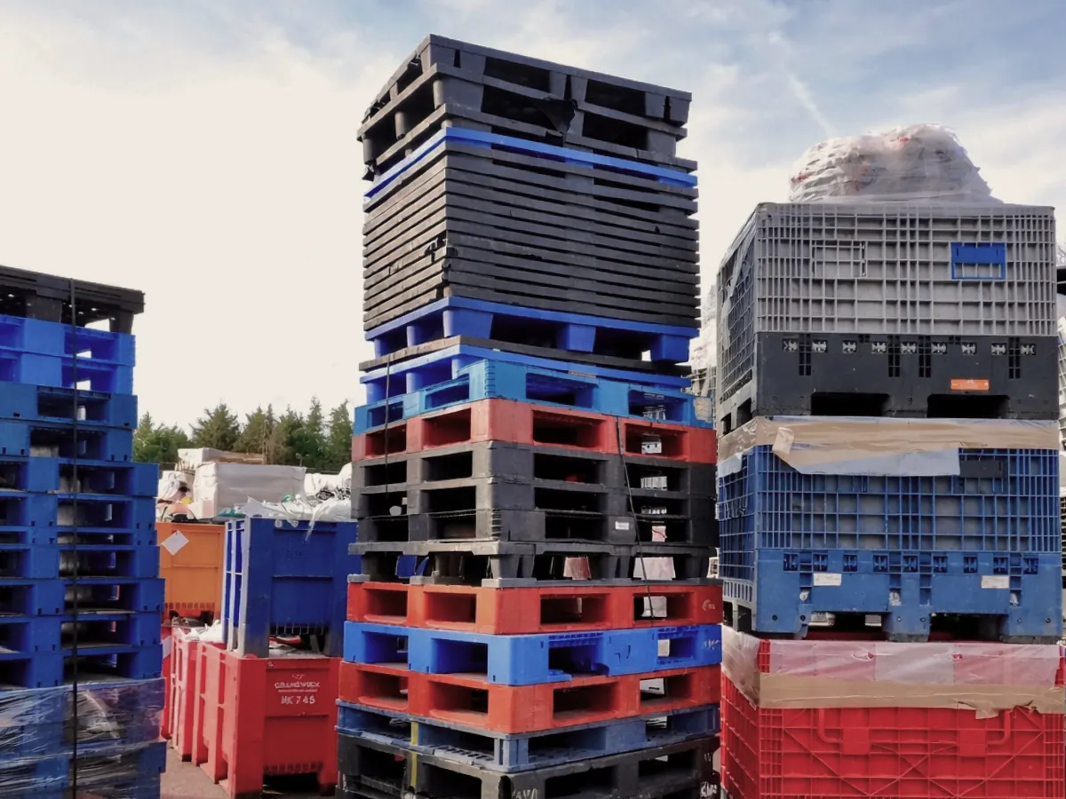 Stacks of plastic crates and pallets for recycling