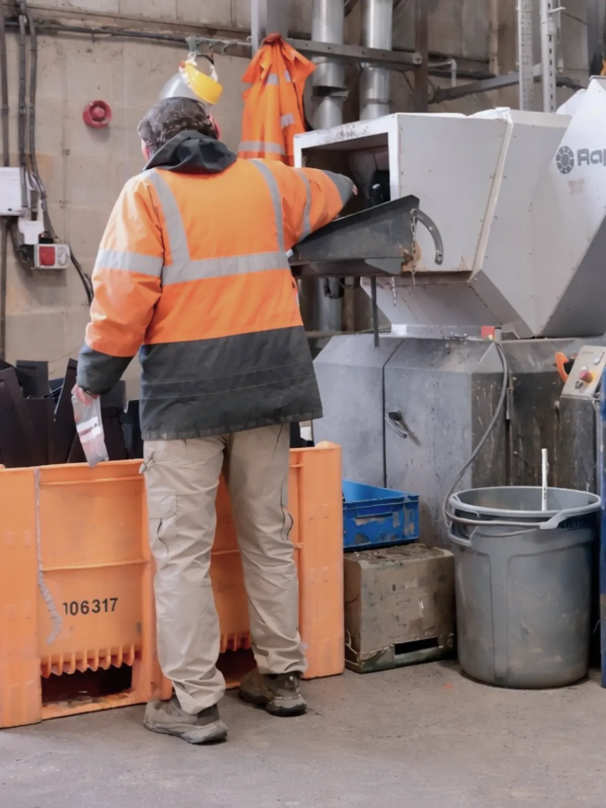 Worker operating plastic recycling machinery at Repro Plastics